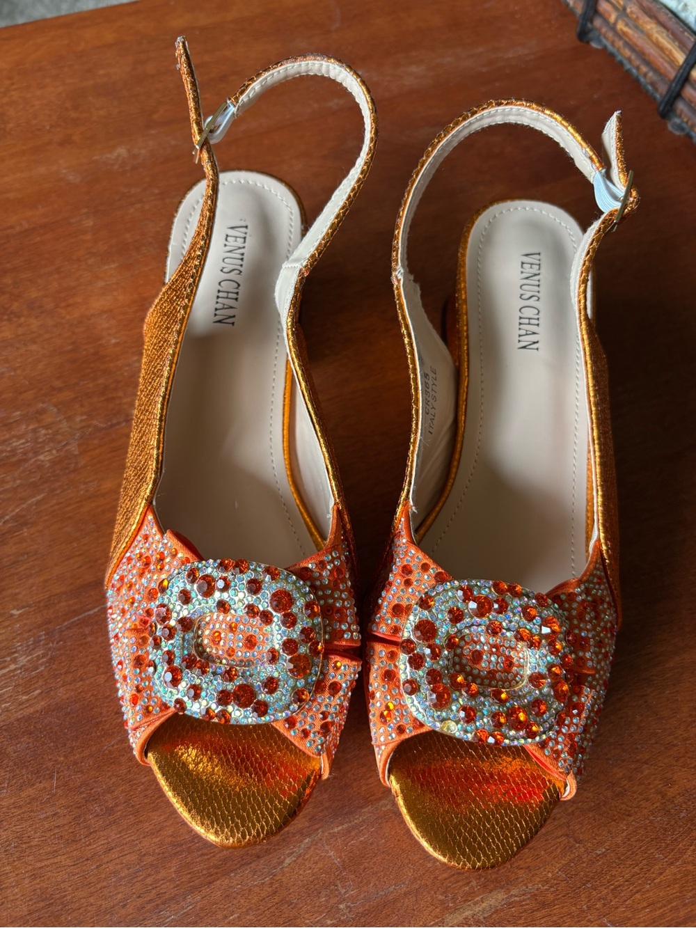 Venus Chan slingback heels w vibrant crystal-encrusted ornament on the peep toe.